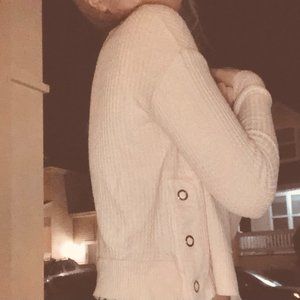 Light pink knitted sweater with side button detail